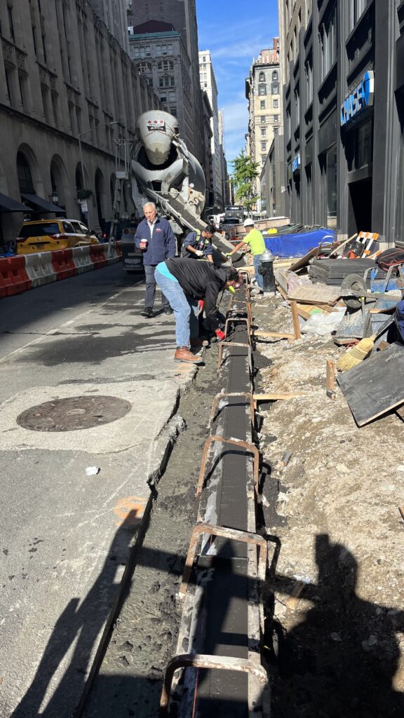Construction Workers in Reflective Vests Working On a Narrow.