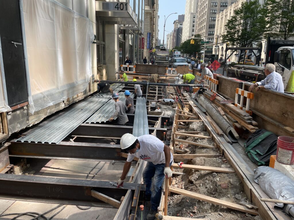 Construction Workers in Hard Hats And Reflective Vests Working on a Construction Site
